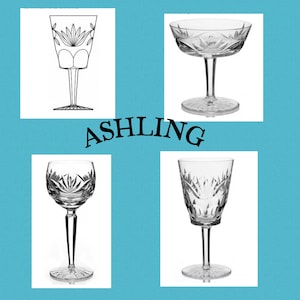 May include: Four clear crystal wine glasses with intricate cut designs. The glasses are displayed on a light blue background with the word "ASHLING" in black script. Each glass has a unique shape and pattern.