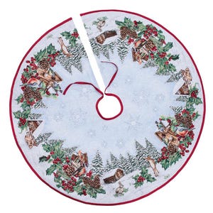 May include: A blue and white Christmas tree skirt with a winter scene featuring birds, houses, and pine trees. The skirt has a red trim and a white ribbon.