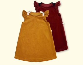 May include: Two sleeveless dresses. One is mustard yellow, the other is burgundy. Both have ruffled cap sleeves and a simple A-line silhouette. The dresses are made of a soft, textured fabric.