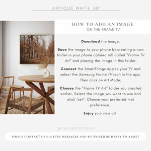 May include: An interior design scene featuring a framed landscape art print, a round wooden table, and two woven chairs. The text reads "ANTIQUE WHITE ART" and instructions on how to add an image to a Frame TV.