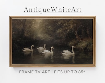 Puede incluir: Obra de arte enmarcada que presenta un paisaje sereno con cuatro cisnes blancos nadando en un río oscuro. La pintura tiene una estética vintage, con un marco dorado. El texto "Antique White Art" está en la parte superior y "FRAME TV ART | FITS UP TO 85"" en la parte inferior.