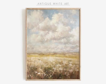 May include: A framed painting of a landscape with a field of white flowers in the foreground and a cloudy sky in the background. The painting is in a light wood frame.