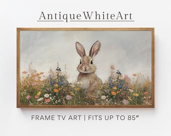 Könnte beinhalten: Ein gerahmter Druck eines braunen Kaninchens, das in einem Feld mit bunten Wildblumen sitzt. Das Kaninchen schaut direkt auf den Betrachter. Der Druck ist in einem Holzrahmen und hat den Text "Antique White Art" oben und "FRAME TV ART | FITS UP TO 85" unten.