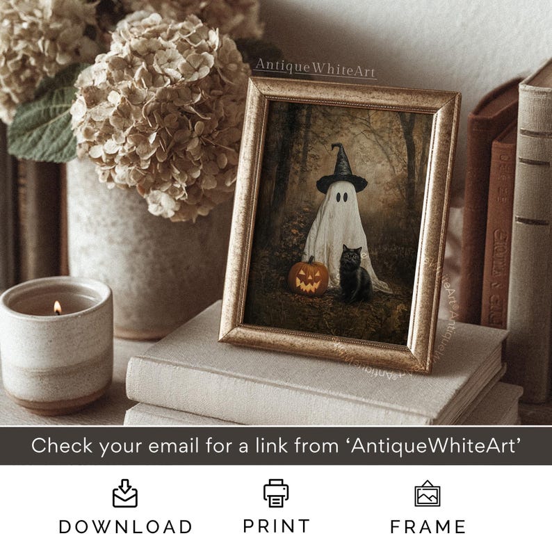 Puede incluir: Una impresi&oacute;n enmarcada con tem&aacute;tica de Halloween que presenta un fantasma con sombrero de bruja, una calabaza tallada y un gato negro. La obra de arte est&aacute; en un marco dorado vintage. El texto "Antique WhiteArt" es visible.