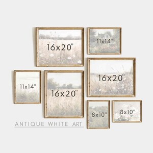 May include: A gallery wall of six antique white picture frames with various sizes and images of nature scenes. The frames are arranged in a staggered pattern on a white wall. The frames are labeled with their dimensions in inches: 11x14, 16x20, 8x10. The text "ANTIQUE WHITE ART" is printed below the frames.