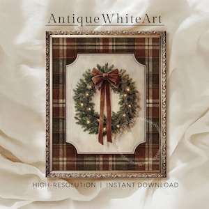 Puede incluir: Una lámina de arte enmarcada titulada AntiqueWhiteArt que muestra una corona de pino verde con pequeñas luces cálidas y un gran lazo de terciopelo marrón. La corona está centrada sobre un fondo crema con un borde de cuadros rojo y verde.