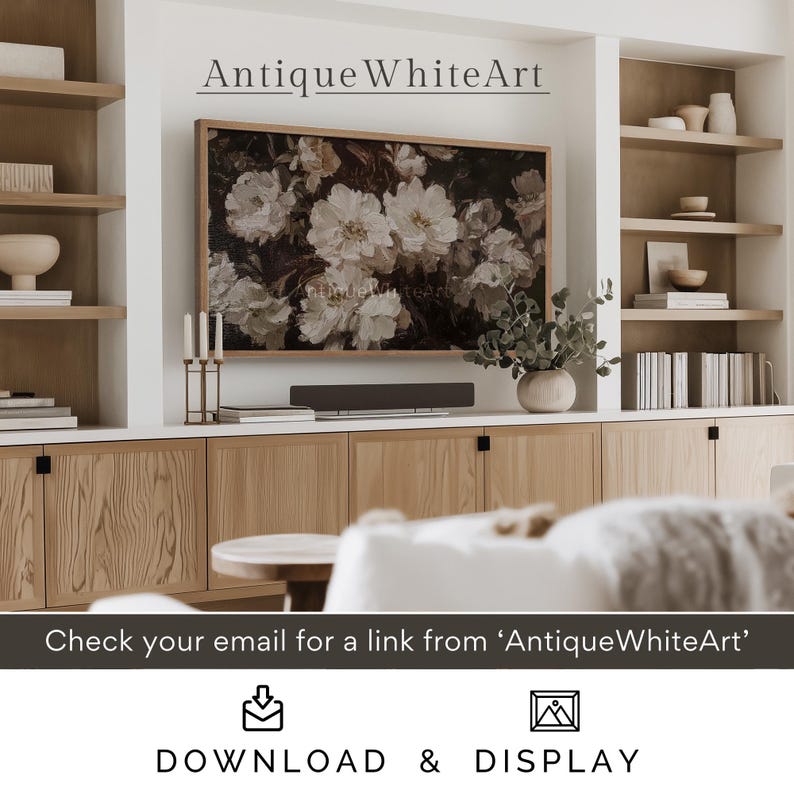 May include: A framed floral print with white flowers on a dark background hangs above a wooden entertainment centre with a soundbar and candles. The text "Antique WhiteArt" is above the print.