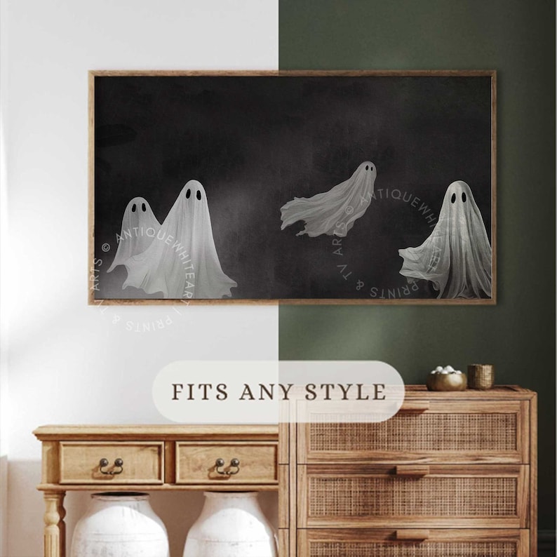 May include: A rectangular framed wall art print featuring four white, translucent ghost figures with dark oval eyes floating against a solid black background. The artwork is displayed in a thin wooden frame, showcasing a dark, atmospheric aesthetic.