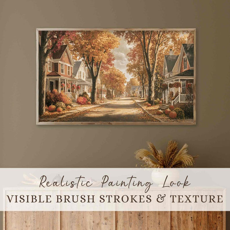 May include: A framed painting shows a street scene with houses and trees in autumnal hues. The artwork has visible brush strokes and texture, with pumpkins and fall foliage adding to the seasonal theme.