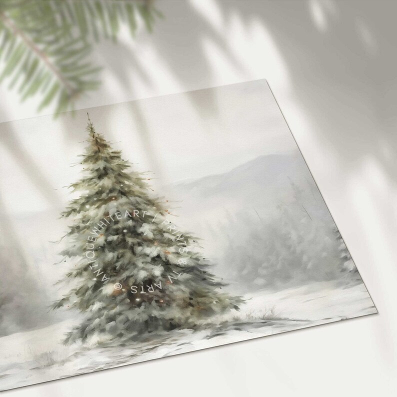 May include: A winter landscape print depicting a snow-laden fir tree with fairy lights. The artwork uses a soft, muted colour palette of whites, greys, and greens, creating a tranquil, snowy scene. The print is from Antique White Art & TV Arts.