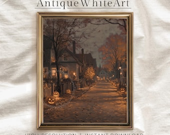 May include: A framed print of a vintage Halloween scene. The artwork depicts a street lined with houses and jack-o'-lanterns, illuminated by streetlights. The text "Antique White Art" is at the top, and "HIGH-RESOLUTION | INSTANT DOWNLOAD" is at the bottom.