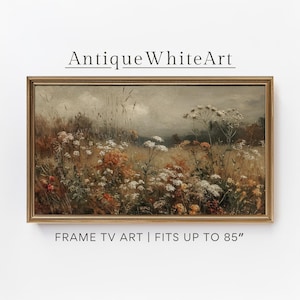 May include: A framed landscape painting featuring a field of wildflowers in shades of white, orange, and yellow. The artwork is set against a muted, cloudy sky. The text "Antique White Art" and "FRAME TV ART | FITS UP TO 85" are visible.