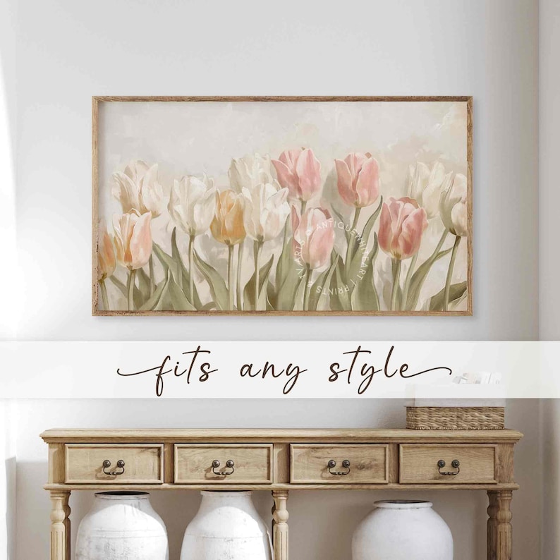 May include: A framed print of a watercolor painting of a bouquet of pink and white tulips with green leaves. The background is a soft, light gray with a subtle watercolor effect. The print is in a simple wooden frame.