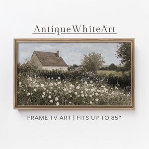 May include: A framed painting of a white cottage with a brown roof surrounded by a field of white flowers. The cottage is set against a backdrop of green trees and a blue sky. The painting is in a gold frame.