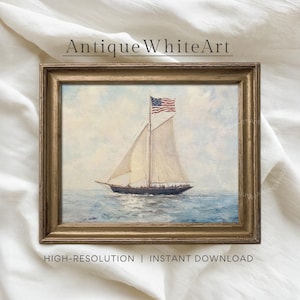 May include: A framed painting of a sailboat on the ocean, with an American flag waving from the mast. The artwork is in a gold-colored frame. The text "Antique White Art" is at the top of the image.