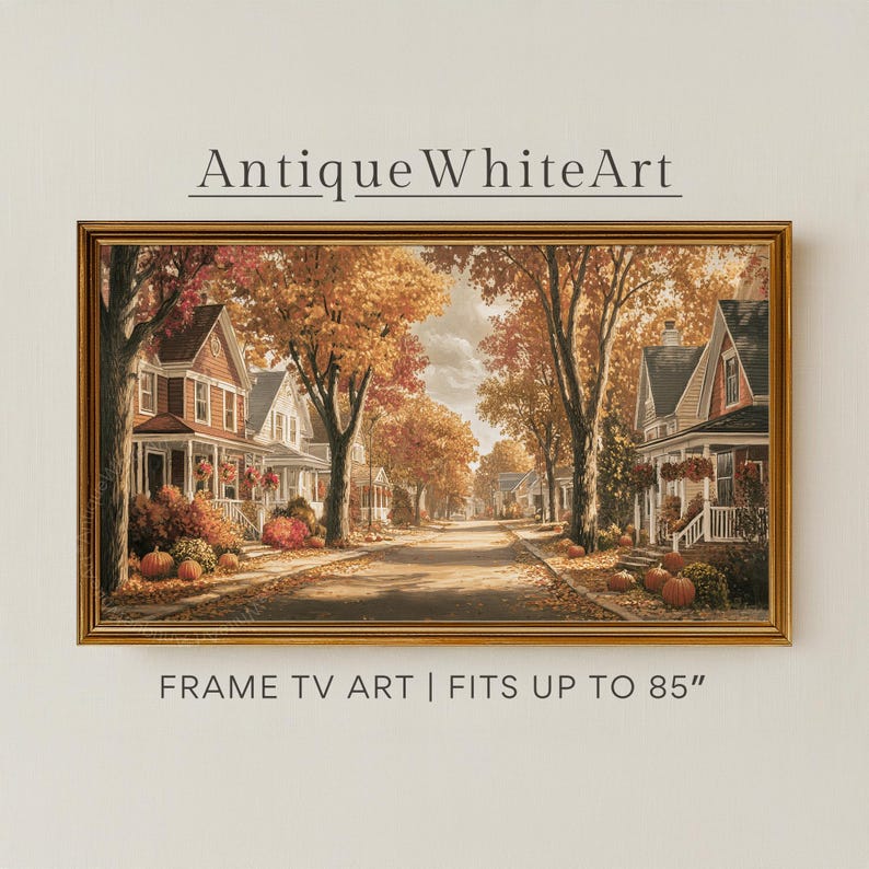 May include: A rectangular framed digital print titled AntiqueWhiteArt, featuring a suburban street scene in autumn with orange-leafed trees, houses, and pumpkins. The text below reads FRAME TV ART | FITS UP TO 85". The frame is gold-toned.