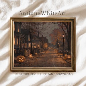 May include: A framed print of a Halloween scene. The artwork depicts a street lined with houses and lit jack-o'-lanterns. The text "Antique White Art" is at the top, and "HIGH-RESOLUTION | INSTANT DOWNLOAD" is at the bottom.