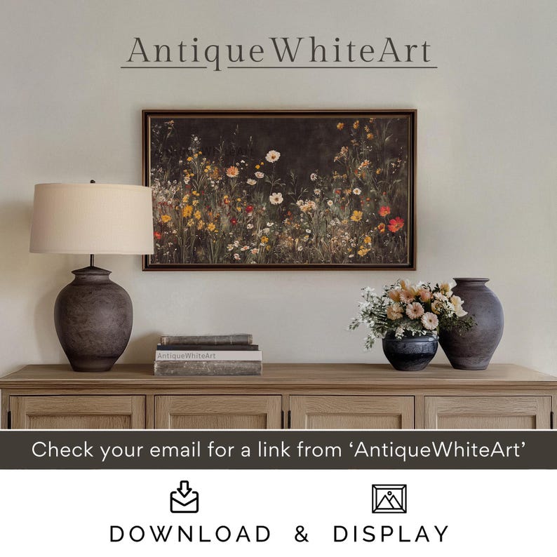 May include: A framed print of a floral arrangement with a dark background. The print is hanging on a white wall above a wooden dresser with two lamps and a vase of flowers. The text "Antique WhiteArt" is visible at the top of the image.