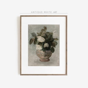 May include: A framed print of a vintage painting depicting a bouquet of white flowers in a pink vase. The flowers are arranged in a loose, natural style, and the vase is decorated with a delicate pattern. The background is a soft, muted blue.