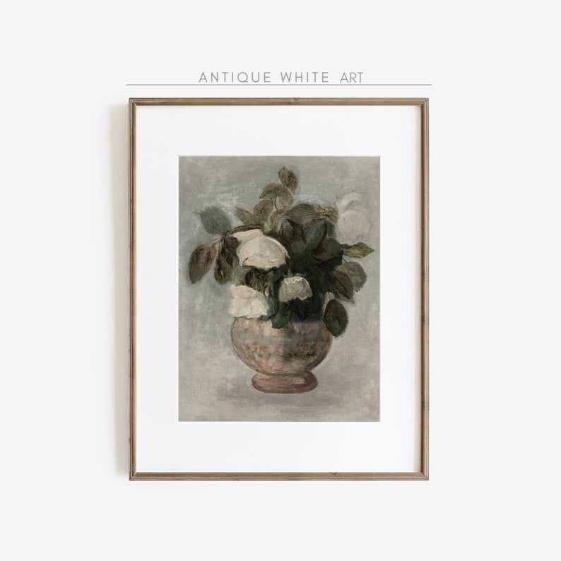 May include: A framed print of a vintage painting depicting a bouquet of white flowers in a pink vase. The flowers are arranged in a loose, natural style, and the vase is decorated with a delicate pattern. The background is a soft, muted blue.