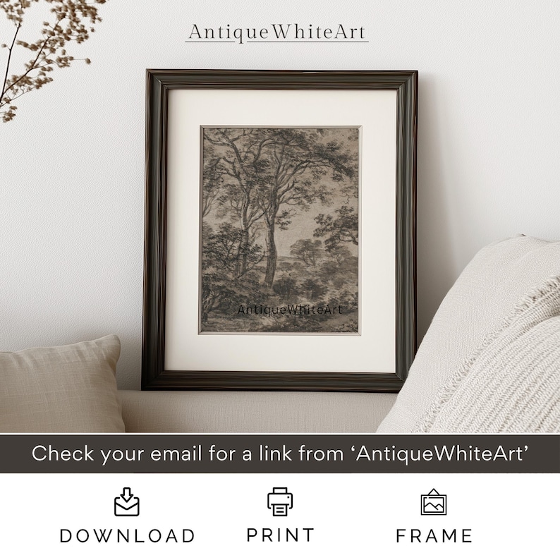 May include: A black and white vintage illustration of a woodland scene with trees and a distant view. The image is framed in a dark brown frame and is displayed on a white wall.