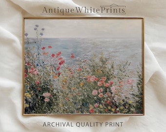 May include: A framed print of a coastal landscape with colorful flowers in the foreground and the ocean in the background. The print is in a gold frame and has the text "Antique White Prints" and "Archival Quality Print".