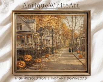 May include: A framed print of a vintage Halloween scene. The artwork depicts a street lined with houses, adorned with pumpkins and fall foliage. Two figures in witch costumes walk down the street. The text "Antique White Art" and "HIGH-RESOLUTION | INSTANT DOWNLOAD" are visible.