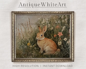 May include: A vintage-style painting of a brown rabbit sitting in a field of wildflowers. The rabbit is looking to the left of the frame. The painting is framed in a gold-colored frame.