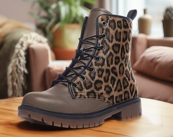 May include: Brown leather ankle boots with a leopard print design. The boots have a lace-up closure and a thick rubber sole.