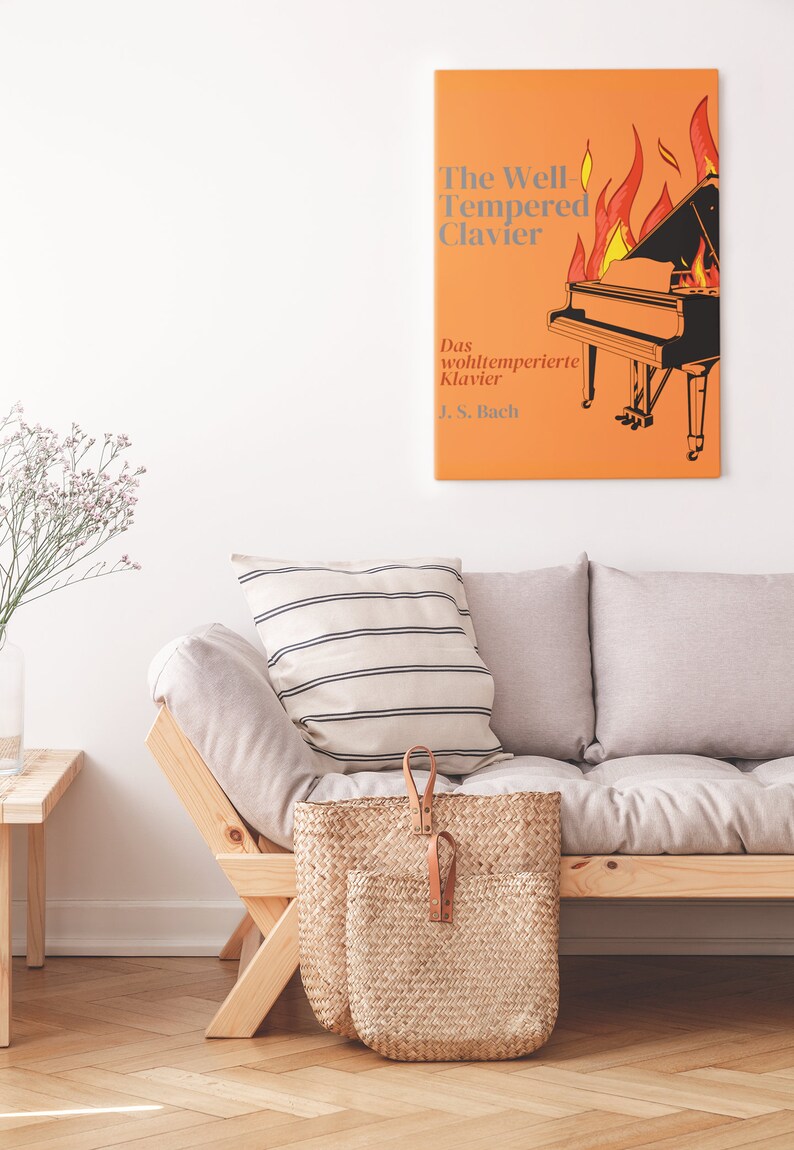 May include: A white couch with a striped pillow and a wicker basket. A framed print of a piano on fire with the text "The Well-Tempered Clavier" and "Das wohltemperierte Klavier J.S. Bach" is hanging on the wall.