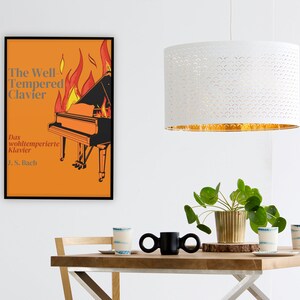May include: A poster with an orange background and a black grand piano on fire. The text on the poster reads "The Well Tempered Clavier" and "Das wohltemperierte Klavier J.S. Bach".