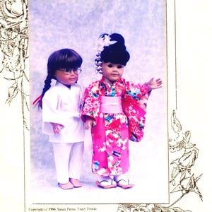 May include: A sewing pattern titled Fancy Frocks Ah! Kimono 2054- 18" & 20" for dolls. The cover features two dolls: one in a white outfit with glasses and braids, and one in a pink floral kimono with a high dark hairstyle and white hair accessory.