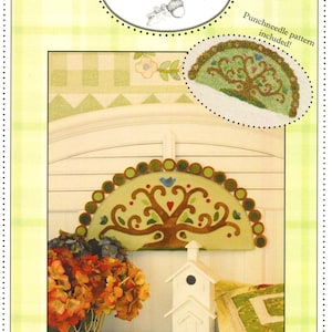 May include: A craft pattern titled "Tree of Life" by Acorn & Gift Company. The image features a punchneedle pattern, a decorative tree design, a white birdhouse, and a basket of orange flowers. The text reads "always remember... from little acorns mighty oaks grow."