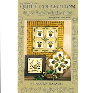 May include: A quilt collection pattern titled "Acorn Harvest" by Janet Miller. The image showcases three quilt designs featuring acorn and leaf motifs in shades of brown, green, and yellow. The cover art includes the text "The City Stitcher Quilt Collection."