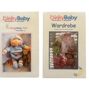 May include: Two sewing patterns for a 14 inch Dinky Baby doll. The first pattern shows a doll wearing a blue outfit and holding a teddy bear. The second pattern shows a wardrobe with 6 pieces of clothing for the doll.