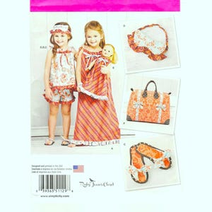 May include: Simplicity pattern 1129A showing girls' clothing and accessories. The pattern includes a dress, shorts set, sleep mask, tote bag, and sandals. The designs feature floral and plaid patterns. Size Euro 3-8.