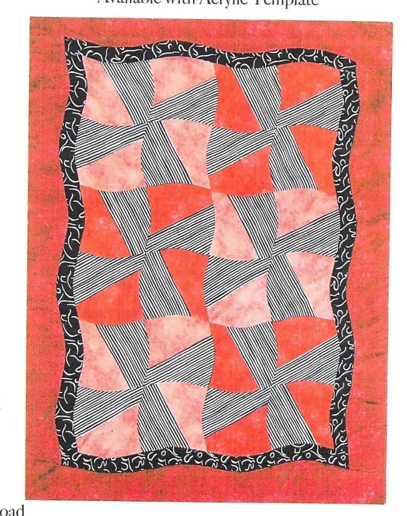 May include: A quilt with a red background and a pattern of alternating red and black and white striped squares. The quilt has a black and white patterned border.