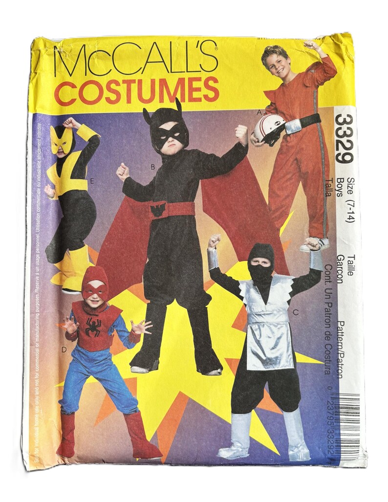 May include: A sewing pattern for children's costumes. The pattern includes four different costumes: a black and red superhero costume, a yellow and black superhero costume, a red and blue superhero costume, and a black and silver ninja costume. The pattern is for sizes 7-14. The pattern number is 3329.