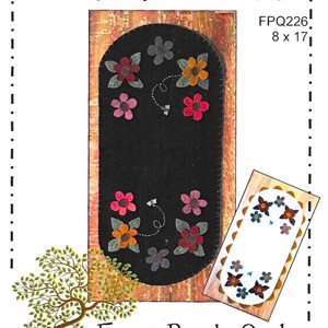 May include: A black felt table runner with colorful floral appliqués, measuring 8 x 17 inches. The design includes the text "Dragonfly Summer" and "Front Porch Quilts". A smaller matching design is also shown.