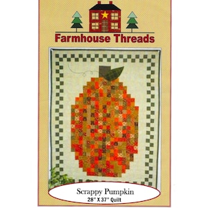May include: A quilt pattern titled "Scrappy Pumpkin" by Farmhouse Threads. The quilt design features a pumpkin shape made of various fabric squares in orange, red, and brown. The quilt measures 71cm x 94cm.