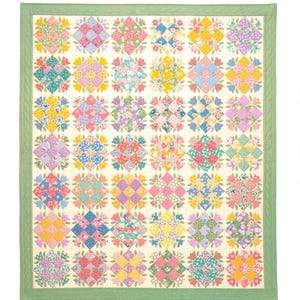 May include: A quilt pattern titled Aunt Maggie's Tulips by Brandywine Design. The quilt features a grid of square blocks with floral patterns in pink, yellow, blue, and green, surrounded by a solid light green border on a white background.
