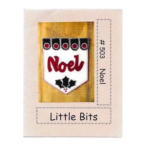 May include: A white felt banner with the word "Noel" in red script, adorned with black holly leaves and red accents. The banner is framed by a black border with red circles. The text "Little Bits" is at the bottom.