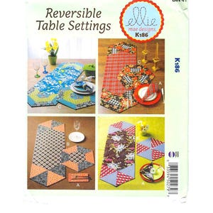 May include: A package titled "Reversible Table Settings" displays four table setting designs. The designs include placemats and table runners with patterns such as floral, plaid, and geometric shapes. The package is labelled "ellie mae designs K186".