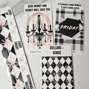 May include: A collection of decorative cards with various designs and text. One card features a chandelier illustration, another says "If it doesn't make Dollars... it don't make cents". Other cards have geometric patterns and bows.