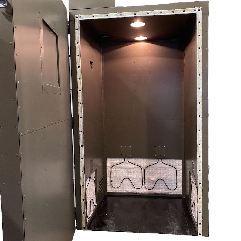 May include: A green metal enclosure with a door open, revealing a white insulated interior with three metal heating elements. The enclosure has a small window on the door.