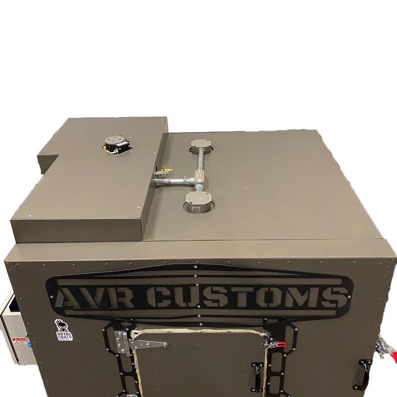 May include: A gray metal box with a black "AVR CUSTOMS" logo on the front. The box has a door with a latch and a handle. There are two vents on the top of the box.
