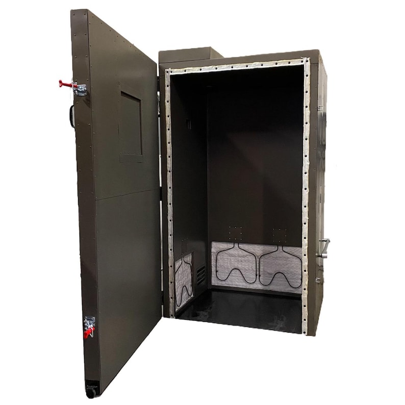 May include: A large, dark green metal industrial oven with a door open, revealing the interior. The oven has a black interior with white insulation and a metal rack.