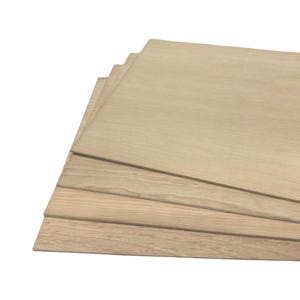 May include: Stack of four light brown wood panels. The panels are smooth and have a natural wood grain pattern.