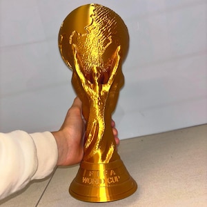 Detailed close-up of 3D printed gold World Cup Trophy showing realistic texture