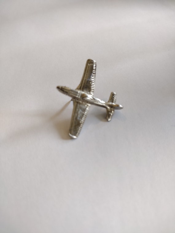 Small silver airplane tie pin, circa 1970